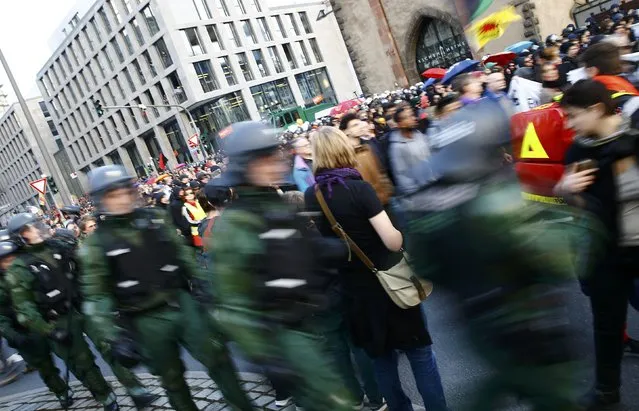 German riot police officers line up along marching protesters in Frankfurt, March 18, 2015. (Photo by Kai Pfaffenbach/Reuters)