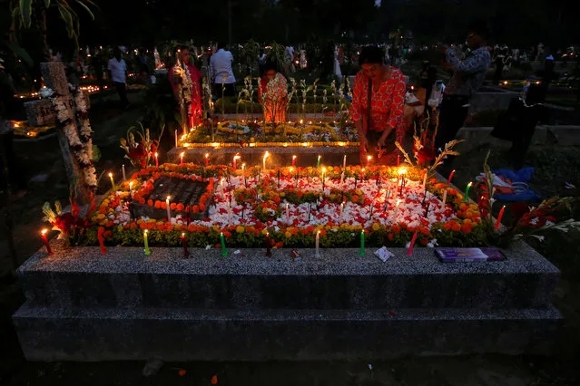 People burn incense sticks and light candles on the graves of their relatives at a cemetery during the observance of All Souls Day, in Kolkata, India, November 2, 2018. (Photo by Rupak De Chowdhuri/Reuters)