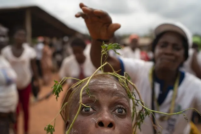 A woman dances as she takes part in a celebration for the return of the former Ivorian president Laurent Gbagbo in Mama, Ivory Coast, Saturday, June 19, 2021. (Photo by Leo Correa/AP Photo)