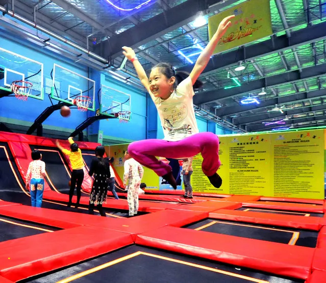 People play at China's largest trampoline theme park on March 23, 2015 in Shanghai, China. China's largest trampoline theme park with an area of more than 2,600 square meters was opened on Monday in Shanghai.  (Photo by ChinaFotoPress/Getty Images)
