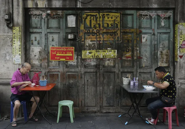 Two men eat breakfast at a roadside eatery in Bangkok, Thailand, Friday, February 5, 2016  (Photo by Sakchai Lalit/AP Photo)