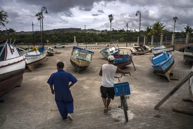 Fishermen inspect their boats after they have been taken out of the bay to avoid damage from the passage of Tropical Storm Elsa, in Havana, Cuba, Monday, July 5, 2021. (Photo by Ramon Espinosa/AP Photo)