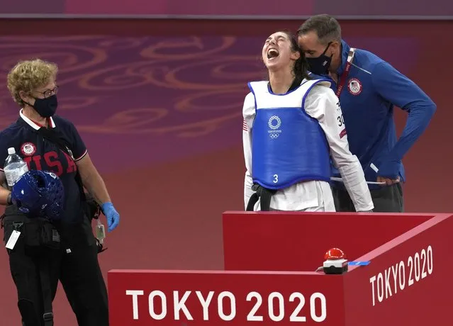 United States's Anastasija Zolotic celebrates with coach after defeating Taiwan's Lo Chia-Ling during the taekwondo women's 57kg match at the 2020 Summer Olympics, Sunday, July 25, 2021, in Tokyo, Japan. (Photo by Themba Hadebe/AP Photo)