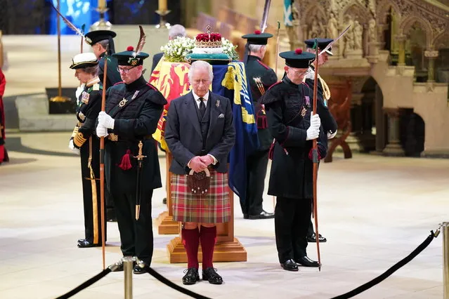 Britain's King Charles III, center, and other members of the royal family hold a vigil at the coffin of Queen Elizabeth II at St Giles' Cathedral, Edinburgh, Scotland,  Monday September 12, 2022, as members of the public walk past. (Photo by Jane Barlow/Pool via AP Photo)