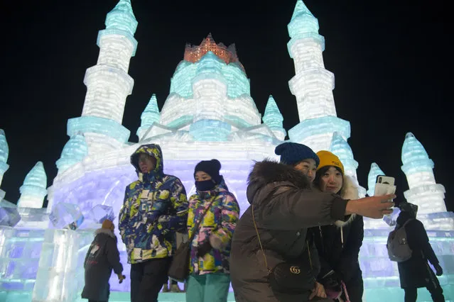 Tourists visit illuminated ice sculptures at Ice and Snow World park on January 5, 2019 in Harbin, China. The Ice and Snow World Park will host the 35th Harbin International Ice and Snow Sculpture Festival from January 5 until the end of February.  (Photo by Tao Zhang/Getty Images)