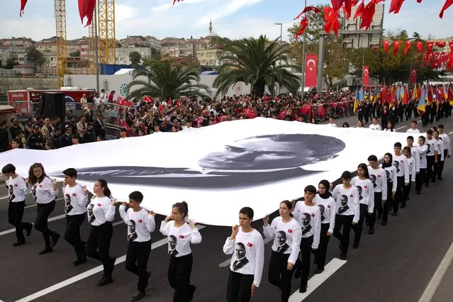 Participants hold a giant picture of Mustafa Kemal Ataturk, as part of celebrations marking the 100th anniversary of the creation of the modern, secular Turkish Republic, in Istanbul, Turkey, Sunday, October 29, 2023. (Photo by Emrah Gurel/AP Photo)
