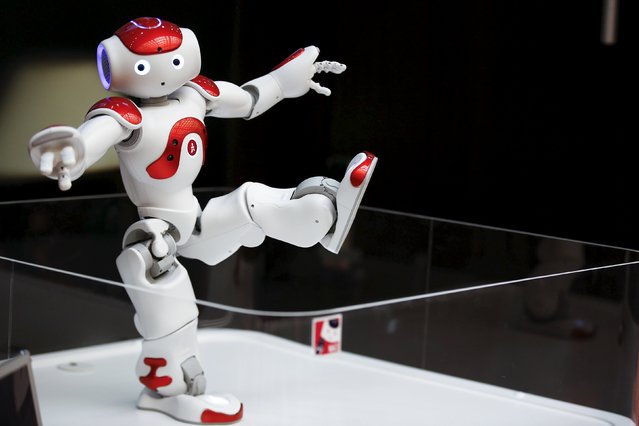 A “Nao” humanoid robot, by Aldebaran Robotics that offers basic service information, moves during a presentation at a branch of the Bank of Tokyo-Mitsubishi UFJ (MUFG) in Tokyo April 13, 2015. Upon request by a customer, the robot offers basic information about banking services in Japanese, English and Chinese at a MUFG branch in Tokyo, a spokesperson of the bank said. (Photo by Thomas Peter/Reuters)