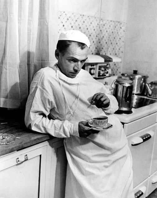 Country Dr. Ernest Ceriani in a dazed state of exhaustion, having a cup of coffee in the hospital kitchen at 2 a.m. after performing a cesarean section where the baby & the mother died due to complications, September 20, 1948. (Photo by W. Eugene Smith/The LIFE Picture Collection/Getty Images)