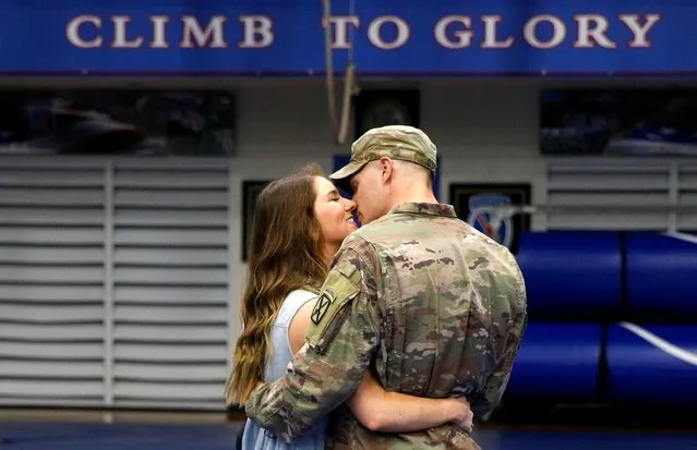 Cpl Preston Dyce, a soldier with the 4th Battalion, 31st Infantry Regiment, 2nd Brigade Combat Team of the 10th Mountain Division, is greeted by his wife Michaela Dyce upon his return home from deployment in Afghanistan, at Fort Drum, New York, September 6, 2021. (Photo by Brendan McDermid/Reuters)