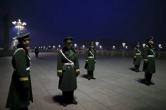 Paramilitary policemen stand guard as the area near the Great Hall of the People is prepared for upcoming annual sessions of the National People's Congress (NPC) and Chinese People's Political Consultative Conference (CPPCC) in Beijing March 3, 2016. (Photo by Aly Song/Reuters)
