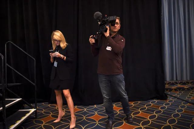 (L-R) Kathryn McQuade, the Media Affairs and Events Coordinator from the House Republican Conference, checks her smartphone while a videographer films before the 2017 “Congress of Tomorrow” Joint Republican Issues Conference in Philadelphia, Pennsylvania, U.S. January 26, 2017. (Photo by Mark Makela/Reuters)