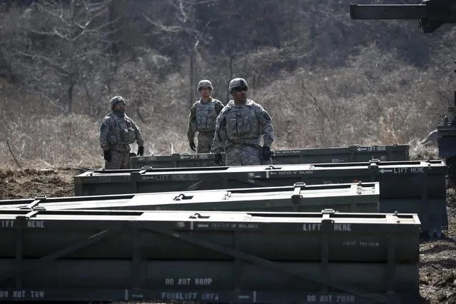 U.S. army soldiers stand between rocket pods as they prepare for a live-fire training exercise of the 6-37th Field Artillery Regiment at a training area near the demilitarized zone separating the two Koreas, in Cheorwon, South Korea, March 9, 2016. (Photo by Kim Hong-Ji/Reuters)