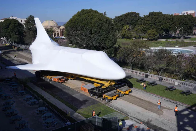 The retired NASA space shuttle Endeavor is moved on the grounds of the California Science Center Friday, January 26, 2024, in Los Angeles. The shuttle is set to be permanently displayed in the California Science Center's Samuel Oschin Air and Space Center currently being constructed. (Photo by Ryan Sun/AP Photo)