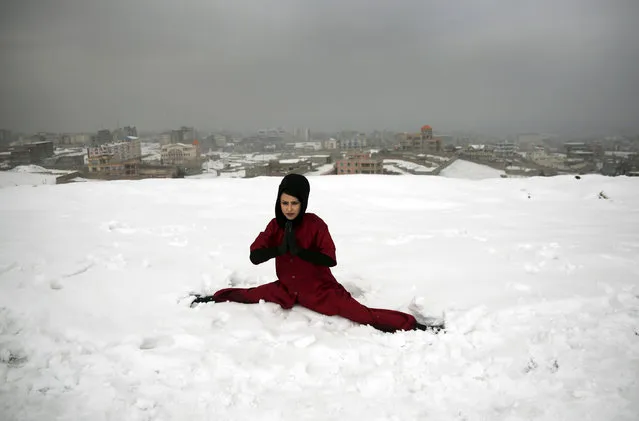 A Shaolin martial arts student practices the splits on a hilltop in Kabul, Afghanistan, Tuesday, January 25, 2017. In religiously conservative Afghanistan, girls are often discouraged from aggressive sports. (Photo by Massoud Hossaini/AP Photos)