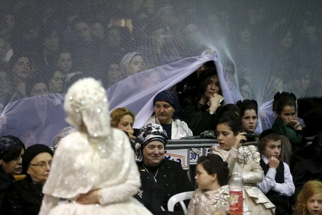 Ultra-Orthodox Jewish women sit next to the bride as they attend her wedding ceremony, in Netanya, Israel early March 16, 2016. (Photo by Baz Ratner/Reuters)