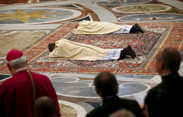 New bishops Miguel Angel Ayuso Guixot from Spain (C) and Peter Bryan Wells from the U.S. lie in front of the altar during their ordination ceremony in Saint Peter's Basilica at the Vatican March 19, 2016. (Photo by Tony Gentile/Reuters)