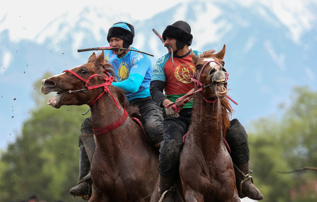 Horsemen play Kokpar, a traditional game between two teams competing to throw a dummy of a goat into a scoring circle, during the first Asian Equestrian Championship near Almaty, Kazakhstan on April 17, 2019. (Photo by Pavel Mikheyev/Reuters)