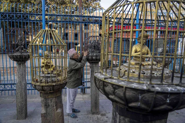 Iron cages are erected around statues as a precaution against theft at Rato Machindranath temple in Lalitpur, Nepal, Thursday, February 8, 2024. An unknown number of sacred statues of Hindu deities were stolen and smuggled abroad in the past. Now dozens are being repatriated to the Himalayan nation, part of a growing global effort to return such items to countries in Asia, Africa and elsewhere. (Photo by Niranjan Shrestha/AP Photo)