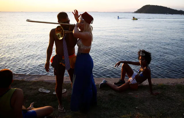 Revellers take part in the annual block party in Paqueta island during pre-carnival festivities on Guanabara bay, Rio de Janeiro, Brazil, February 18, 2017. (Photo by Ricardo Moraes/Reuters)