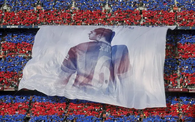 Supporters display a giant banner of Barcelona's Xavi Hernandez during their Spanish first division soccer match against Deportivo de la Coruna at Camp Nou stadium in Barcelona, Spain, May 23, 2015. Xavi announced on Thursday his retirement from Barcelona at the end of the current season. He will play next season at Al Sadd in Qatar. (Photo by Albert Gea/Reuters)