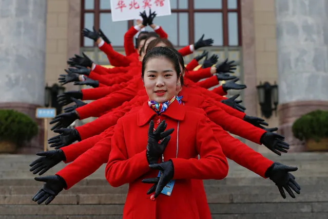 Hostesses pose for a picture during the opening session of the Chinese People's Political Consultative Conference (CPPCC) in the Great Hall of the People in Beijing on March 3, 2017. The CPPCC plays a largely symbolic role, with members meeting once a year to discuss social and economic policies, among them wealthy business leaders and members of powerful political families. (Photo by yrone Siu/Reuters)