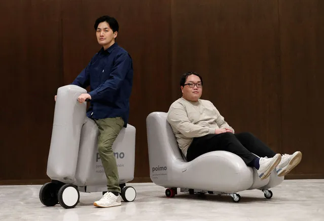 Hiroki Sato, the University of Tokyo’s researcher, and Ryosuke Yamamura, Mercari R4D’s researcher, pose with the scooter-type and sofa-type poimo, portable and inflatable mobility devices, during an interview with Reuters at the school's lab in Tokyo, Japan, December 16, 2021. (Photo by Kim Kyung-Hoon/Reuters)