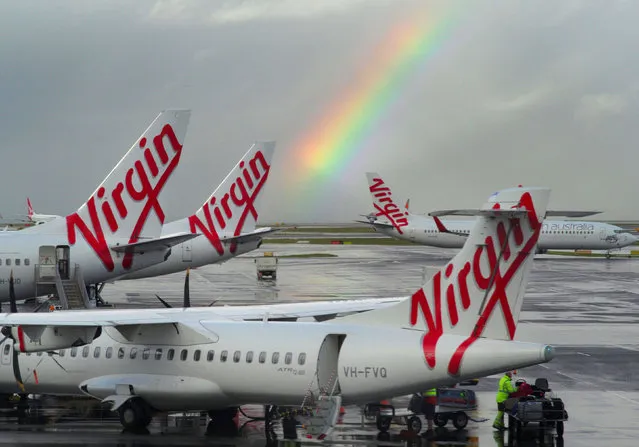 A rainbow from a passing rain shower sits over Virgin Australia aircraft at Sydney's Airport in Australia, August 5, 2016 after the company reported full year earnings results. (Photo by Jason Reed/Reuters)