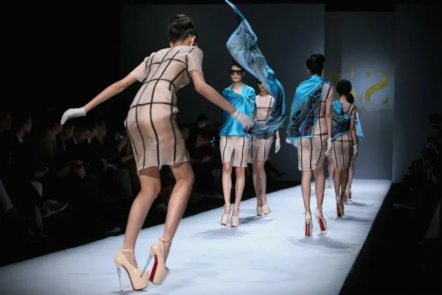 A model almost falls on the runway during the SECCRY Hu Sheguang Collection 2014 Show during Mercedes-Benz China Fashion Week Autumn/Winter 2014/2015, March 30, 2014, in Beijing. (Photo by Feng Li/Getty Images)