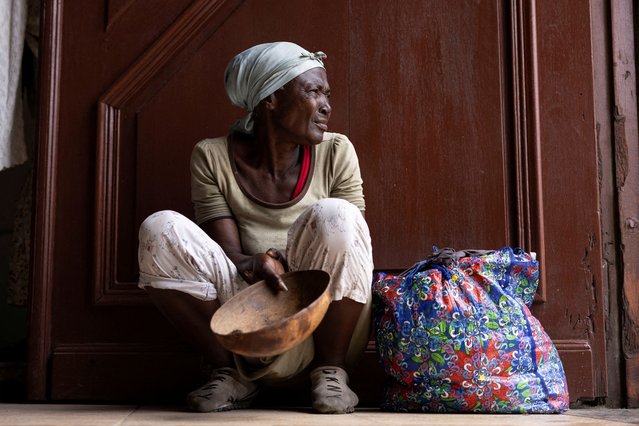 A woman begs for money at the entrance of the Our Lady of the Assumption Cathedral during Sunday mass in Cap-Haitien, Haiti on April 28, 2024. (Photo by Ricardo Arduengo/Reuters)