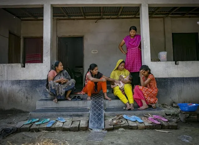 Meghla (in pink) looks on as her mother feeds her baby while her sisters and grandmother look on, on March 7, 2017 in Khulna division, Bangladesh. (Photo by Allison Joyce/Getty Images)