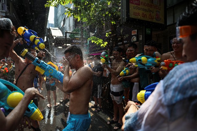Chinese tourists play with water as they celebrate the Songkran holiday which marks the Thai New Year in Bangkok, Thailand, on April 13, 2024. (Photo by Chalinee Thirasupa/Reuters)
