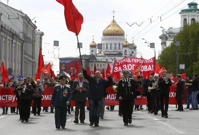 Supporters of the Communist party take part in a May Day rally, with the Christ the Saviour Cathedral seen in the background, in Moscow, Russia, May 1, 2016. (Photo by Sergei Karpukhin/Reuters)