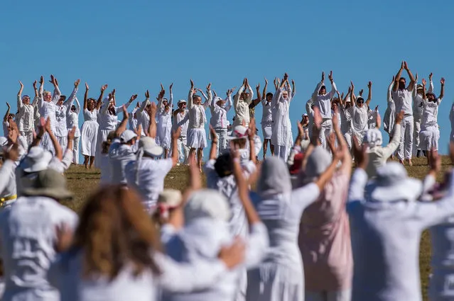 Members of an international religious movement called the White Brotherhood perform ritual dance on the top of the Rila Mountain, near Babreka lake, on August 19, 2019. Hundreds of pilgrims converge high in Bulgaria's Rila mountains on August 19-21 to mark their “spiritual” new year with a collective meditative dance known as “paneurhythmy”, that they believe connects them to cosmic rhythms and beats the blues. (Photo by Nikolay Doychinov/AFP Photo)