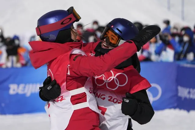 Silver medal winner China's Eileen Gu, left, and Gold medal winner Switzerland's Mathilde Gremaud celebrate after the women's slopestyle finals at the 2022 Winter Olympics, Tuesday, February 15, 2022, in Zhangjiakou, China. (Photo by Lee Jin-man/AP Photo)