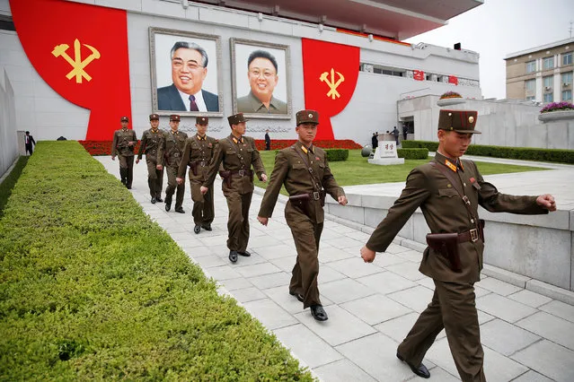 Soldiers walk under pictures of former North Korean leaders Kim Il Sung and Kim Jong Il at the capital's main ceremonial square after a mass rally and parade, a day after the ruling party wrapped up its first congress in 36 years by elevating him to party chairman, in Pyongyang, North Korea, May 10, 2016. (Photo by Damir Sagolj/Reuters)