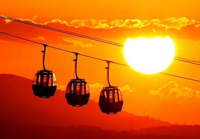 A view from Amisos hill as the sun sets behind the silhouettes of a telpher on July 08, 2019 in Turkey's Samsun. (Photo by Veysel Altun/Anadolu Agency/Getty Images)