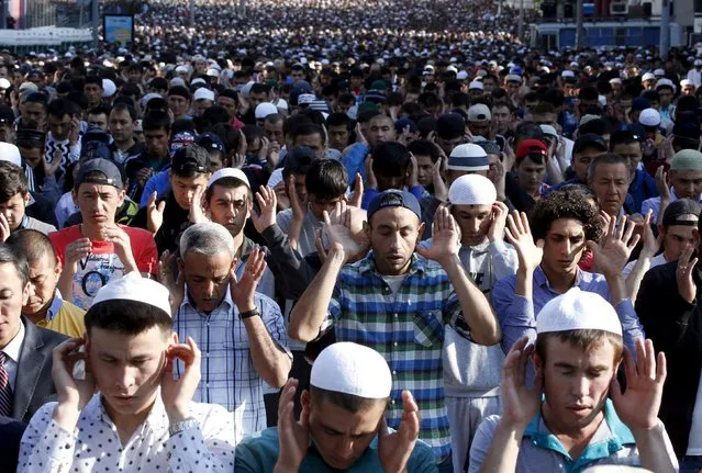 Muslims attend the morning prayers of Eid al-Fitr holiday, marking the end of the holy month of Ramadan, in Moscow, Russia, July 17, 2015. (Photo by Sergei Karpukhin/Reuters)