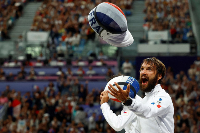 France's Romain Cannone reacts after a point as he competes against Czech Republic's Jiri Beran in the men's epee individual round of 32 bout during the Paris 2024 Olympic Games at the Grand Palais in Paris, on July 28, 2024. (Photo by Albert Gea/Reuters)