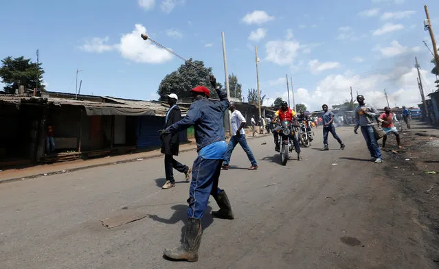 A supporter of Kenya's opposition Coalition for Reforms and Democracy (CORD) uses a sling to hurl stones towards their opponents during a protest against at the Independent Electoral and Boundaries Commission (IEBC) to demand the disbandment of the electoral body ahead of next year's election in Nairobi, Kenya, June 6, 2016. (Photo by Thomas Mukoya/Reuters)