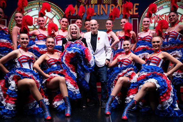 US WWII veteran Harold Terens, 100, and his wife Jeanne Swerlin, 96, pose with dancers in traditional French cancan outfits in the backstage of the Moulin Rouge cabaret during their honeymoon in Paris, on June 11, 2024. The couple celebrated their mariage at the town hall of Carentan-les-Marais, in Normandy, on June 8, just days after being honoured on the 80th anniversary of the D-Day landings. (Photo by Julien de Rosa/AFP Photo)