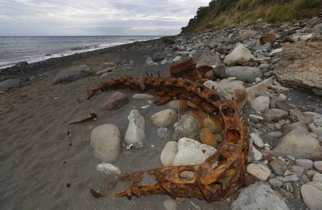 Debris that has washed onto the Jamaique beach in Saint-Denis is seen on the shoreline of French Indian Ocean island of La Reunion, August 3, 2015. On Sunday, a small piece of metal debris found washed up on a beach on Reunion was taken into police custody. (Photo by Jacky Naegelen/Reuters)