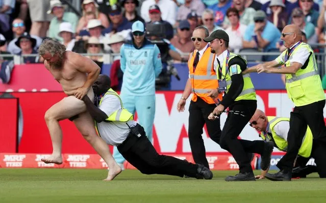 A pitch invader attempts to evade a security official during the 2019 Cricket World Cup group stage match between England and New Zealand at the Riverside Ground, in Chester-le-Street, northeast England, on July 3, 2019. (Photo by Lee Smith/Action Images via Reuters)
