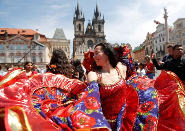 Participants of the Khamoro World Roma Festival dance through the historical centre of Prague, Czech Republic on June 3, 2022. (Photo by David W. Cerny/Reuters)