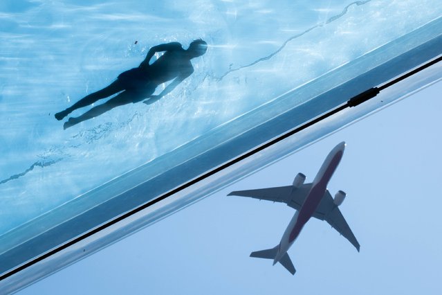 Swimmers in the Sky Pool, a transparent swimming pool suspended 35 meters above ground between two apartment buildings, during hot weather in Nine Elms, central London on Monday, August 12, 2024. (Photo by James Manning/PA Images via Getty Images)