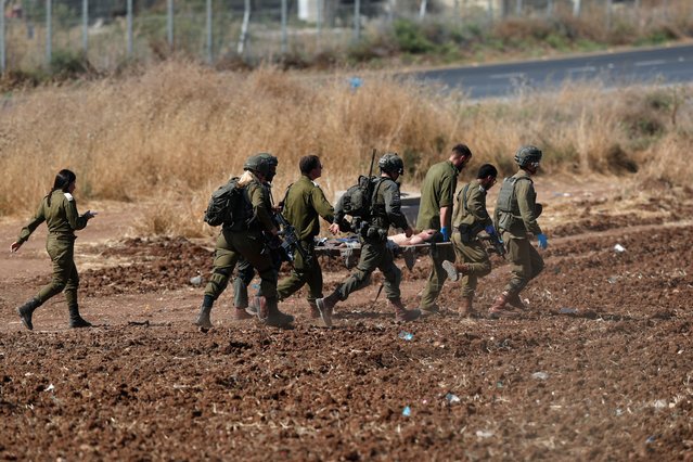 Israeli soldiers carrying a wounded soldier to be transferred by a military helicopter to a hospital, near the West Bank city of Jenin, 03 July 2023. The Israeli army announced on 03 July that they launched a large-scale operation in Jenin. According to the Palestinian Health Ministry, at least eight people were killed and dozens of others wounded in the Jenin raid. (Photo by Atef Safadi/EPA/EFE/Rex Features/Shutterstock)