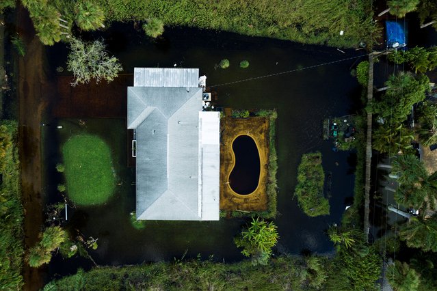 A drone view shows a flooded house after Hurricane Milton made landfall in Iona, Florida, U.S., October 10, 2024. (Photo by Ricardo Arduengo/Reuters)