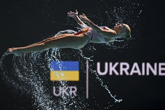 A member of Team Ukraine competes during the final of highlights of the artistic swimming at the 19th FINA World Championships in Budapest, Hungary, Saturday, June 25, 2022. (Photo by Anna Szilagyi/AP Photo)