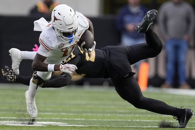 Texas wide receiver Silas Bolden, left, dives extra yards past Vanderbilt safety Dontae Carter, right, during the second half of an NCAA college football game Saturday, October 26, 2024, in Nashville, Tenn. (Photo by George Walker IV/AP Photo)