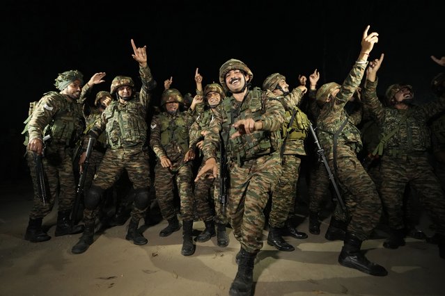 Indian army soldiers dance to celebrate Diwali, near Line of Control that divides Kashmir region between India and Pakistan, in Akhnoor sector, about 66 kilometers (41 miles/AP from Jammu, India, Monday, October 28, 2024. (Photo by Channi Anand/AP Photo)
