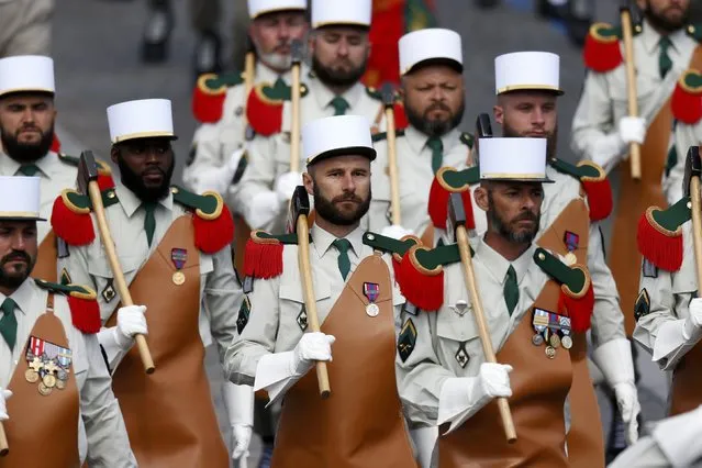 Pioneers of the 1st Foreign Legion regiment carry their axes as they march during the Bastille Day military parade on the Champs Elysees in Paris, France, July 14, 2016. (Photo by Benoit Tessier/Reuters)